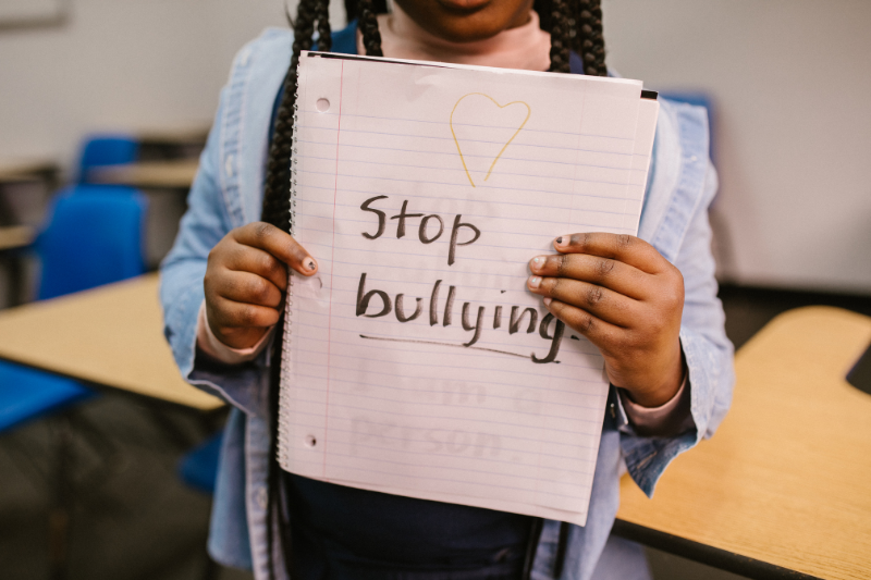 girl holding stop bullying sign