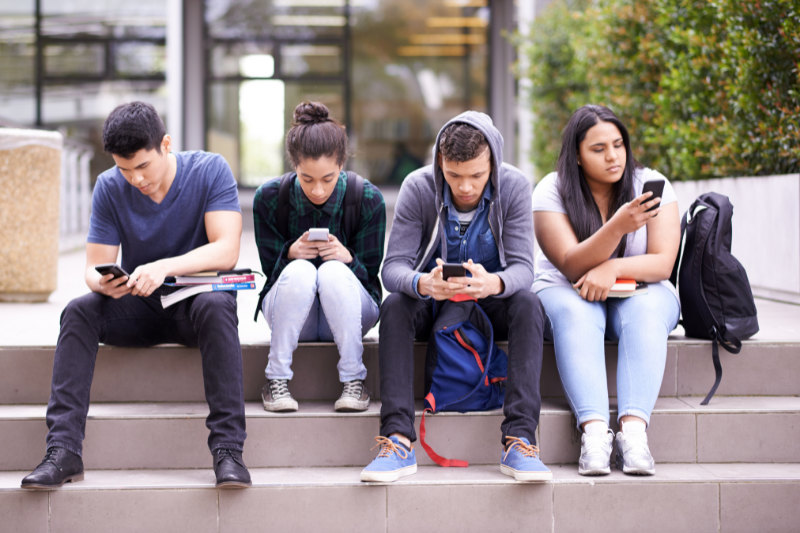 teens focused on their cell phones