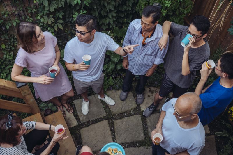 top view of a group gathered outside at a party having a conversation