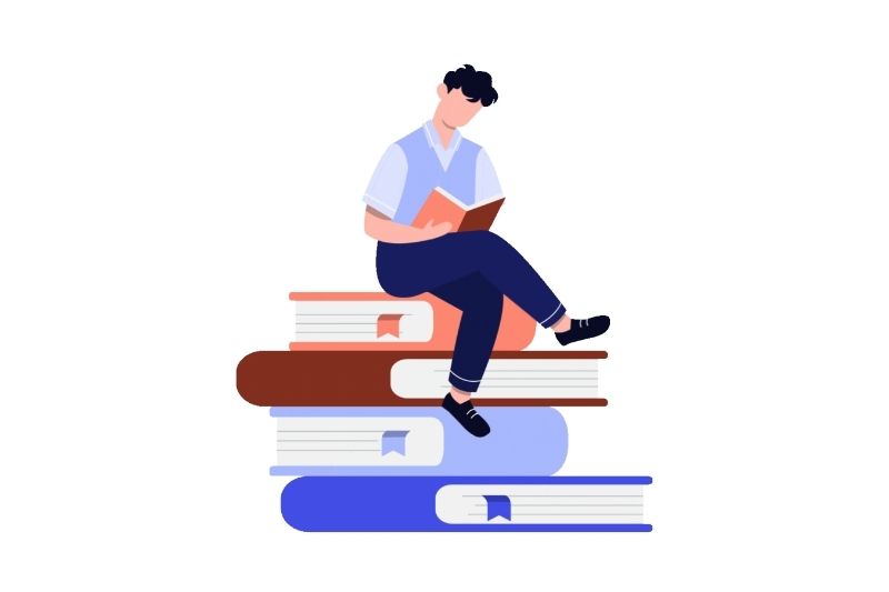 Teen sitting on books reading