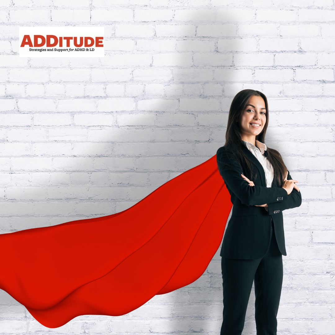 Woman with superwoman cape on standing in suit