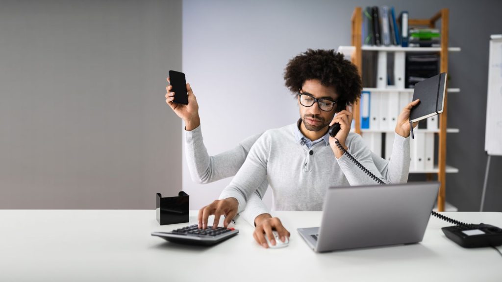 Man multitasking at desk