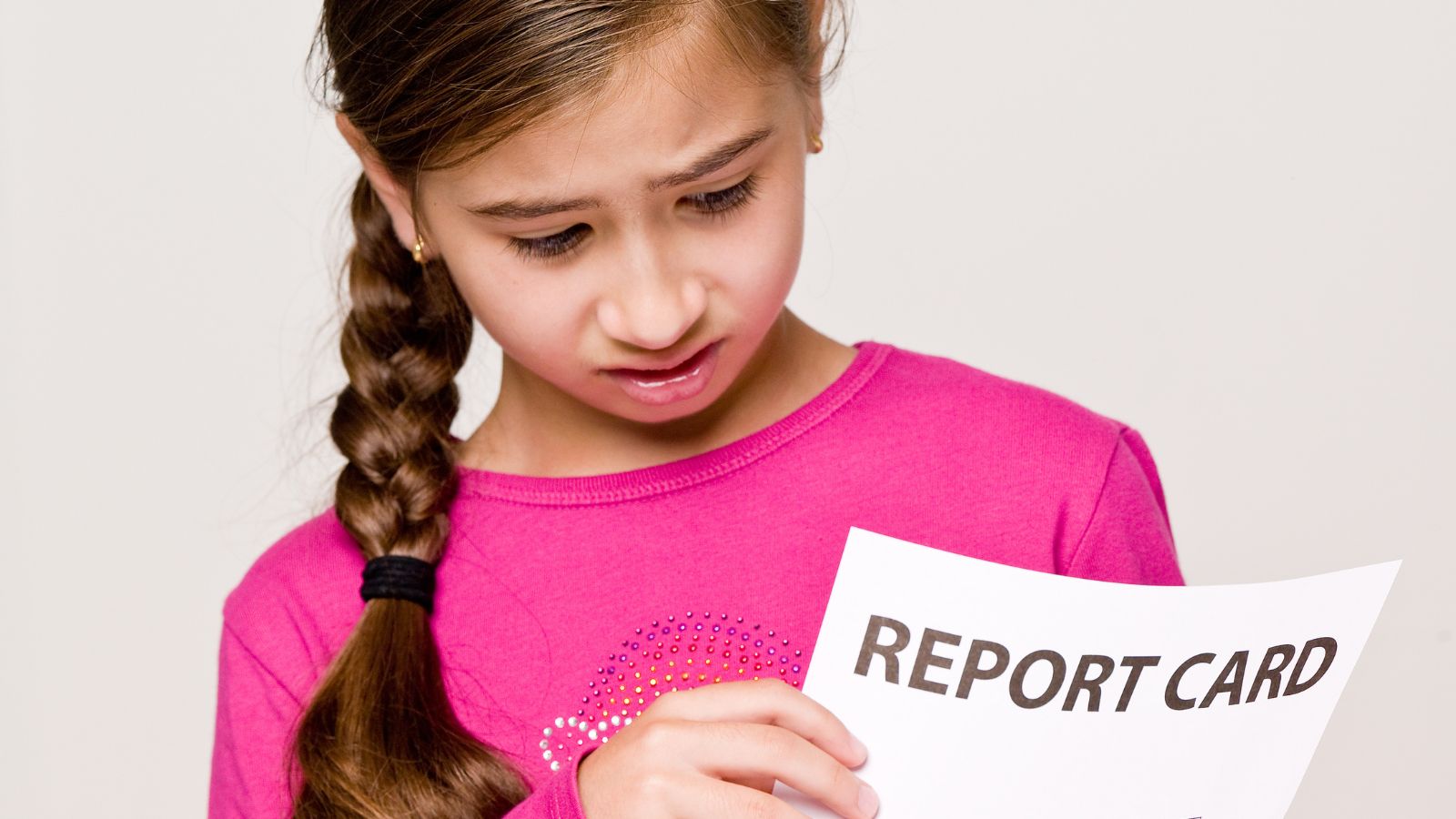 Girl looking at report card
