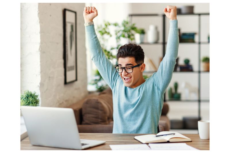 Man excited to finish on computer
