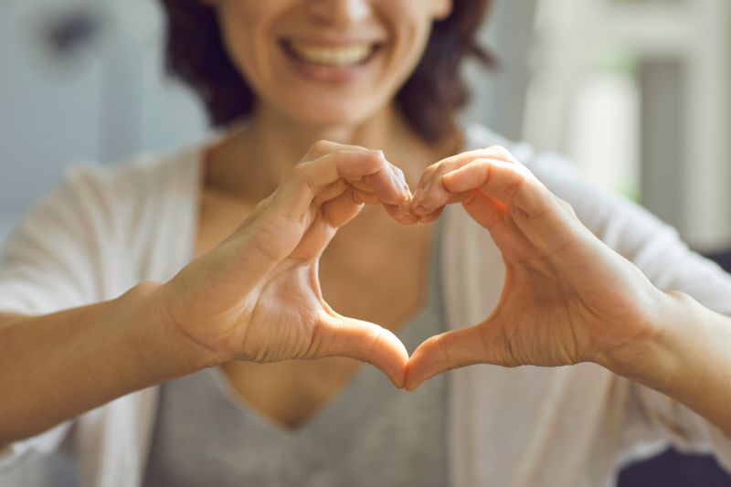 woman making heart sign with her hands expressing gratitude