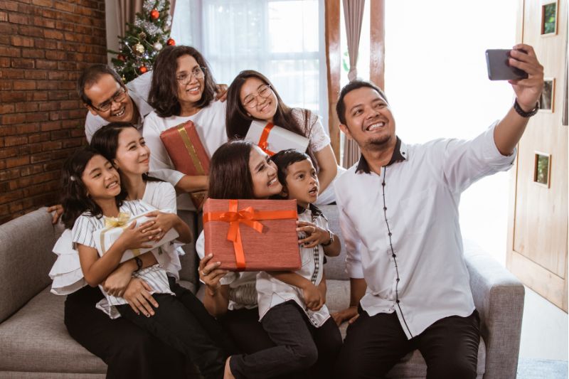 family posing for selfie with christmas gifts 