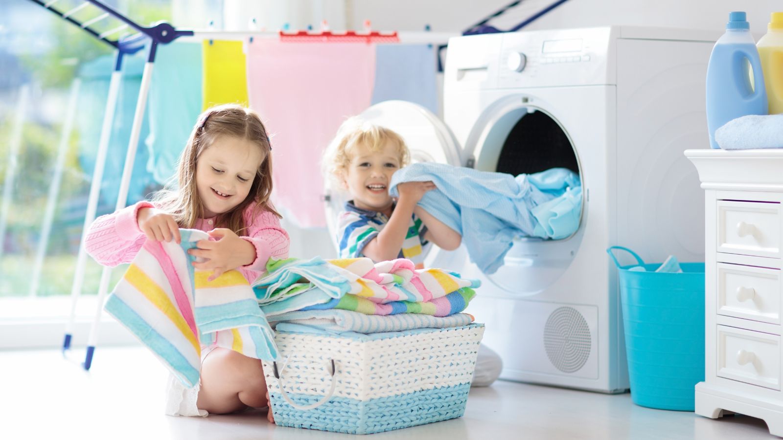 Kids completing chores folding clothes out of the dryer