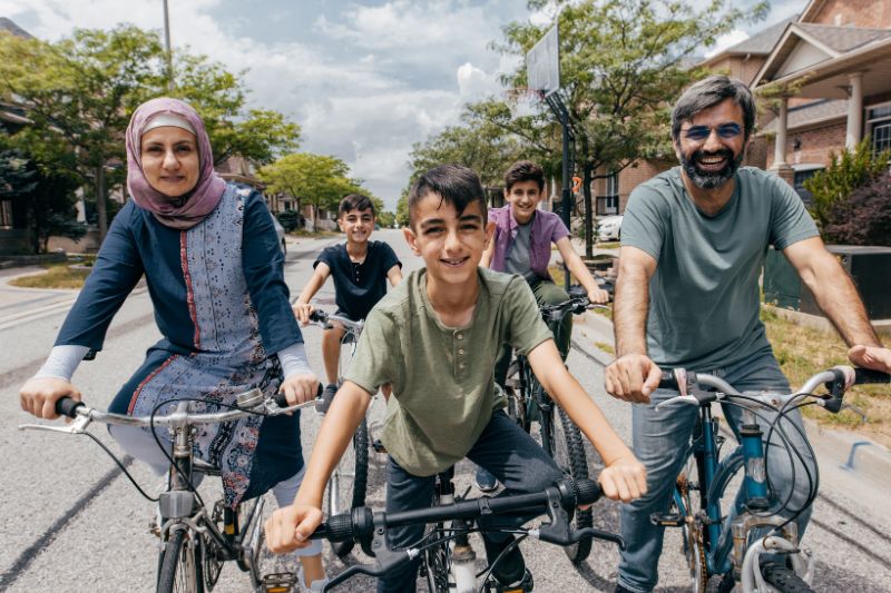 family biking through neighborhood