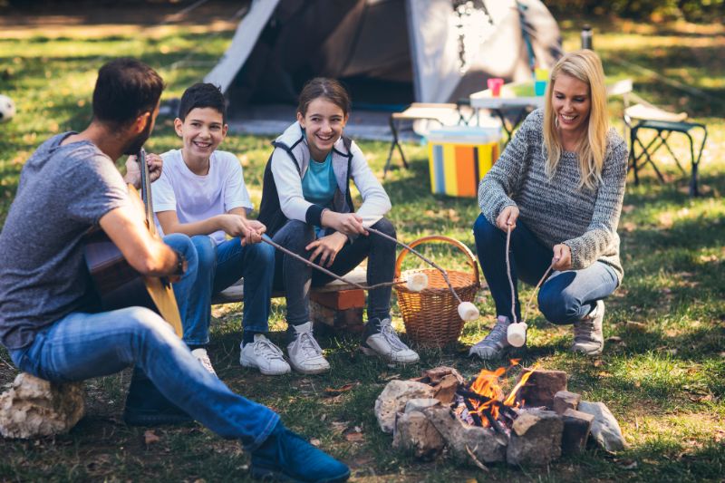 family roasting marshmallows camping