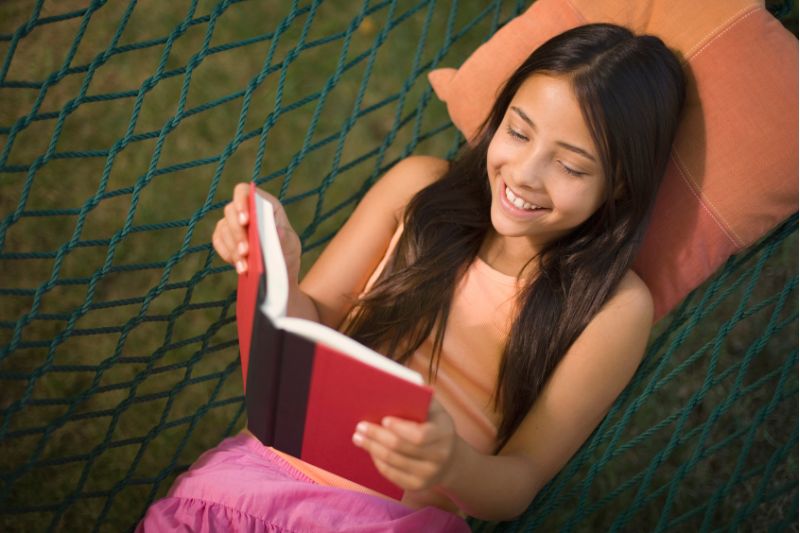 girl reading in hammock