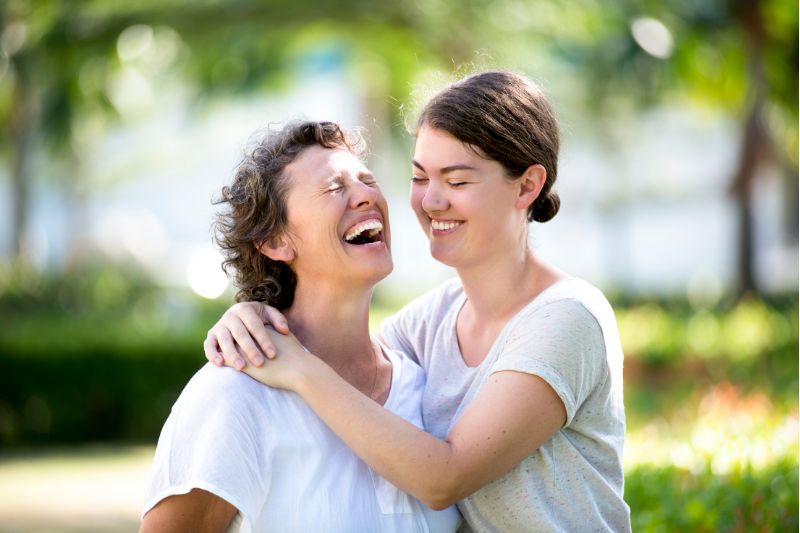 mother and teen daughter laughing together
