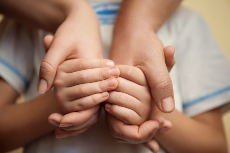 child holding mother's hands