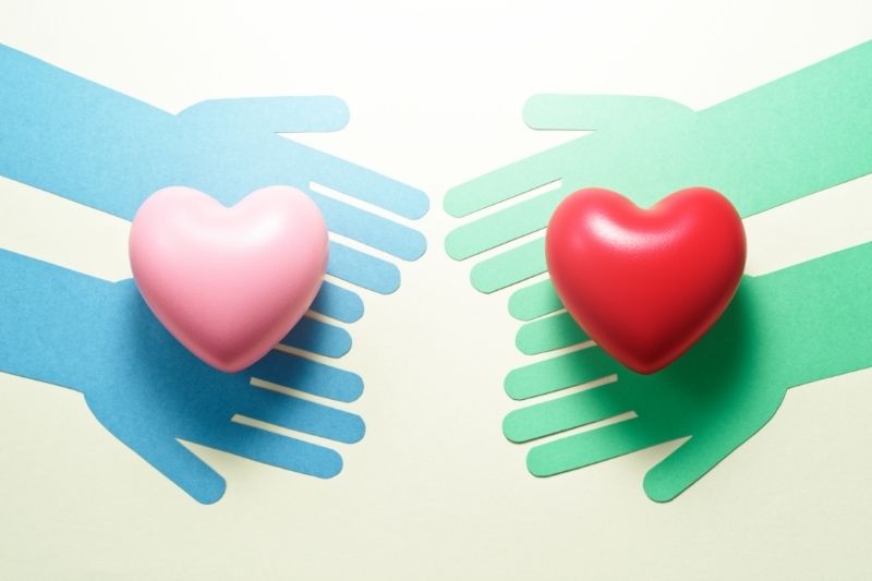 hands holding hearts graphic